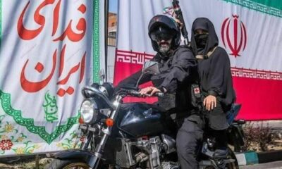 یک تصویر متفاوت/ بانوی مسلح روی موتور در میادین تهران + عکس